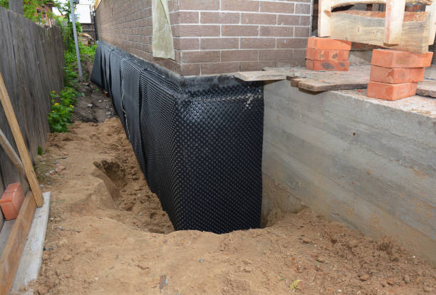 Happy homeowners after waterproofing job in Saranac